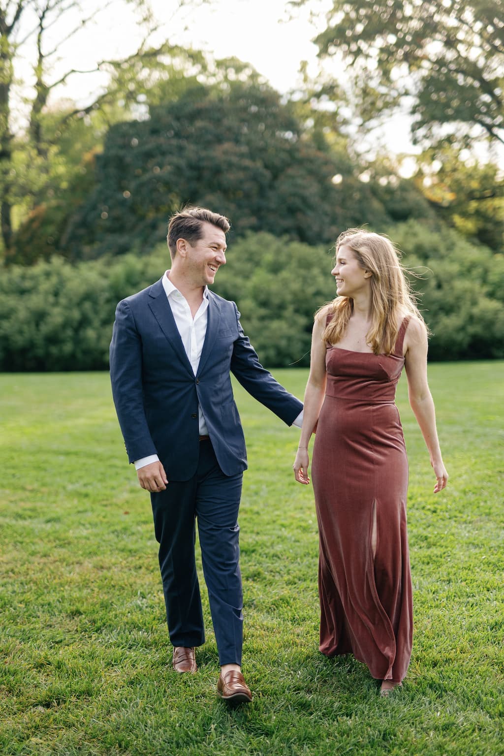 Eli and Georgia walking together, wearing fancy clothes.